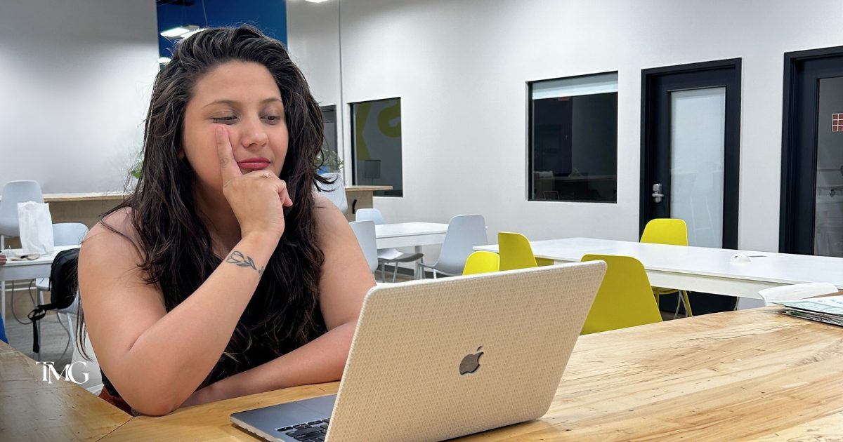 Giselle from TMG Marketing Partners analyzing client feedback on Google Reviews and managing a GMB Google My Business profile on her laptop