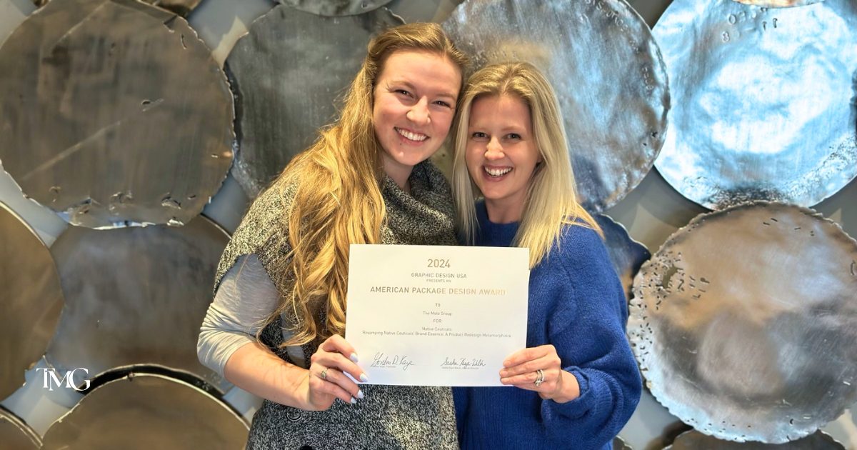 Lilia and Cristalle smiling and holding the 2024 GDUSA Package Design Award certificate for outstanding creative packaging design