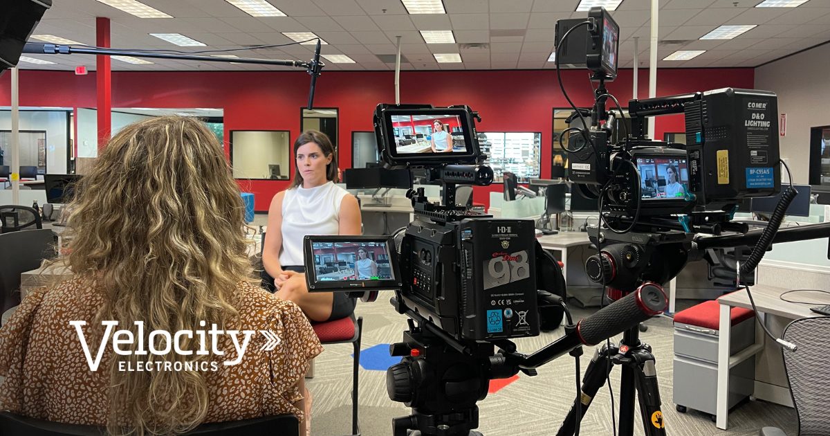 Behind-the-scenes photo of a professional video shoot at Velocity Electronics headquarters, capturing brand storytelling interviews and production setup.