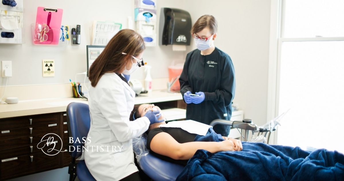 Dr. Bass and assistant treating a patient at Bass Dentistry, with clean clinical visuals reinforcing the practice’s professionalism and alignment with the modernized dental practice website.