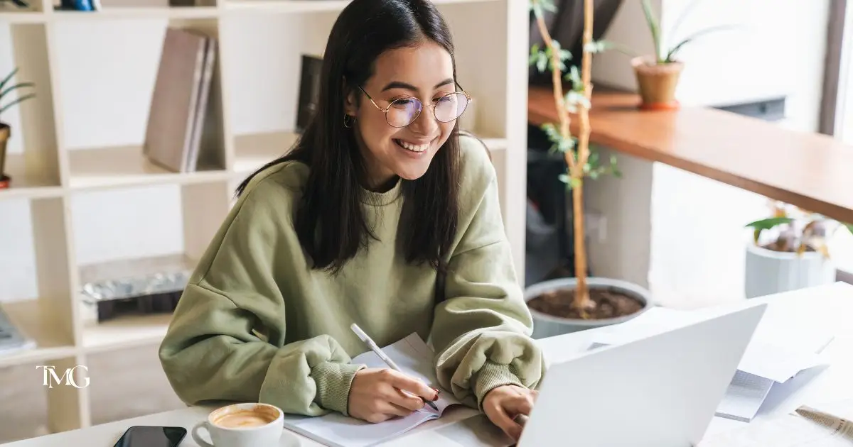 A modern woman working on her laptop working on keyword mapping to improve SEO.