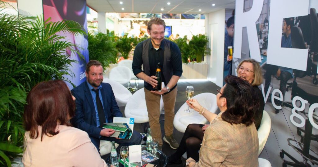 Interactive and social booth lounge area with Velocity team engaging visitors