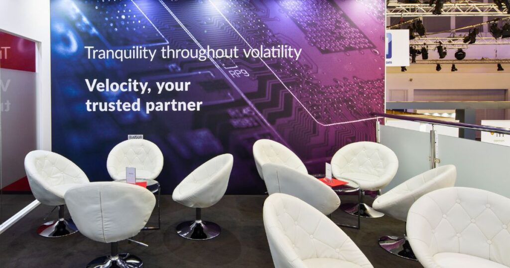 Upstairs booth seating with large branded backdrop: Tranquility through volatility
tradeshow-booth-design