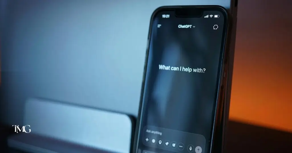 Close-up of a smartphone screen displaying the ChatGPT app with the prompt “What can I help with?”, representing the user interface of AI technology and illustrating how to use ChatGPT for everyday assistance and content creation.