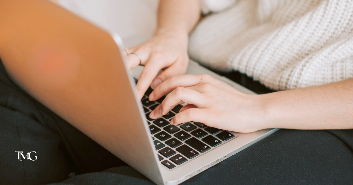 Close-up of a person typing on a laptop keyboard, representing user frustration and website behavior analytics related to rage clicks.