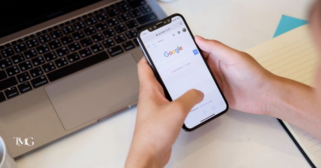 Person using a smartphone to search Google, illustrating what a Google Business Profile looks like in local search.