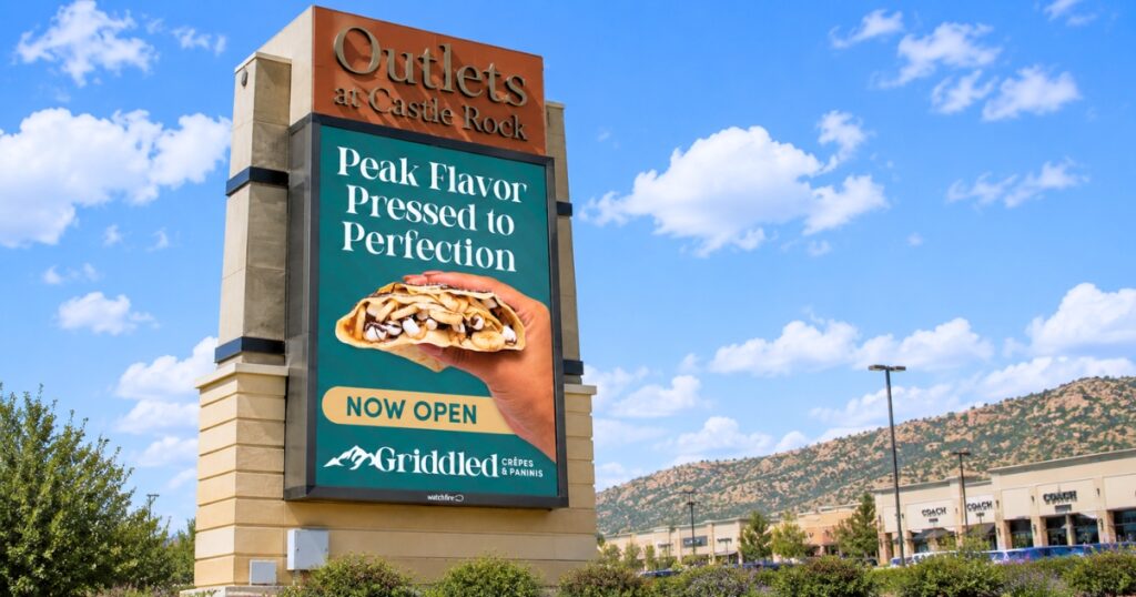 Digital sign at Outlets at Castle Rock advertising Griddled Crêpes & Paninis' grand opening with a stuffed s'mores crêpe.
