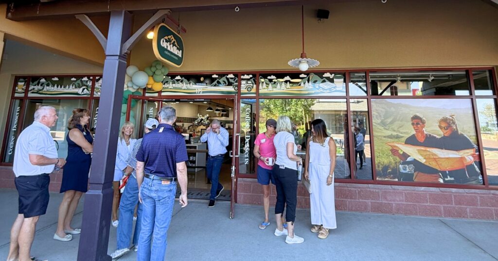 Guests gather outside the Griddled Crêpes & Paninis storefront in Castle Rock, CO during the restaurant's grand opening.