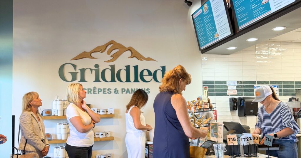 Customers order at the counter beneath menu boards inside the newly opened Griddled Crêpes & Paninis in Castle Rock.