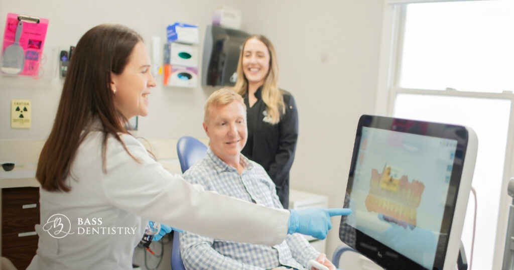Dentist and assistant reviewing a patient's digital scan at Bass Dentistry, reflecting the dental marketing strategy behind their patient experience.